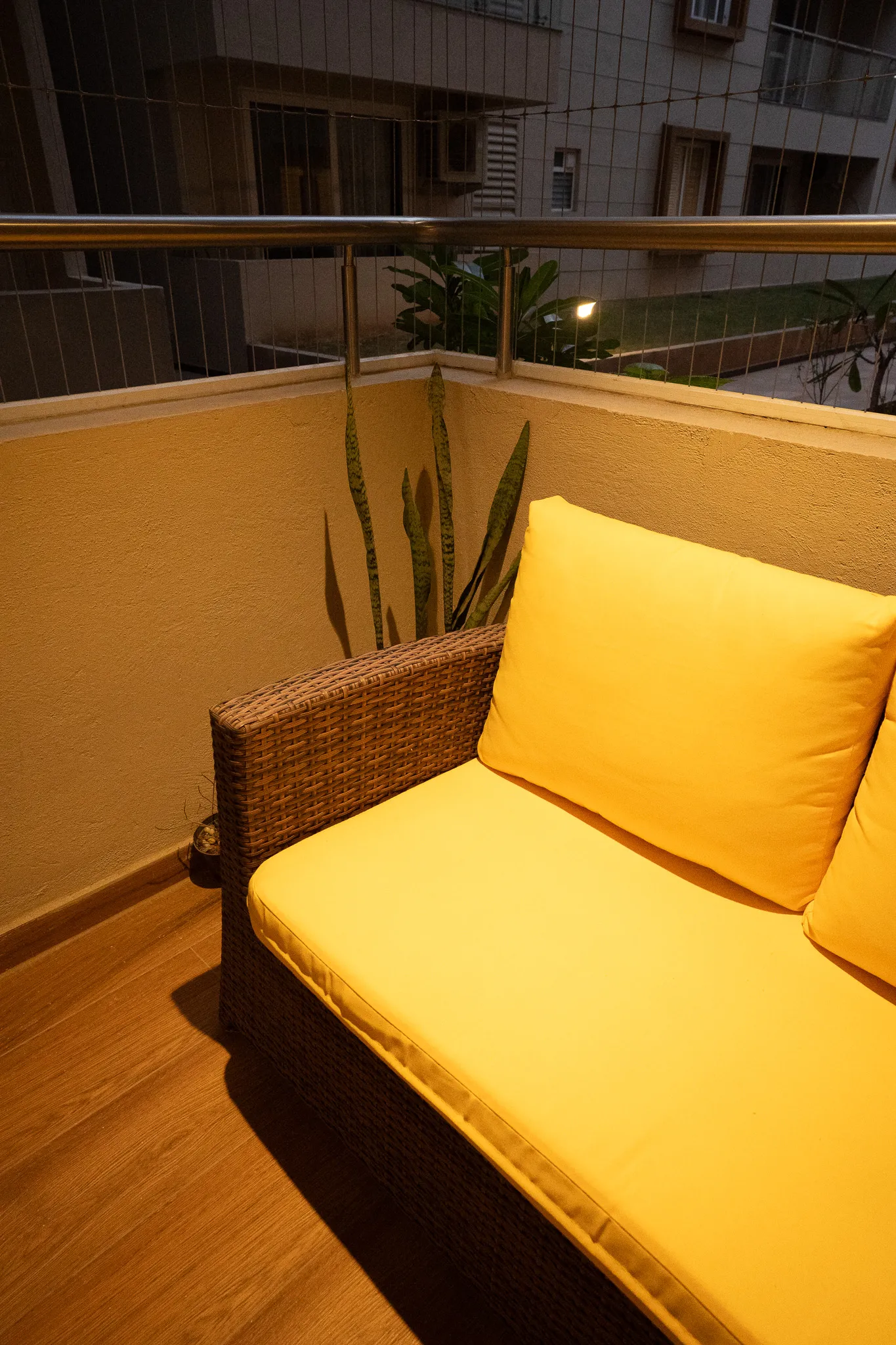 Balcony seating with yellow cushions — Divyarjuna
